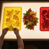Mesa de luz encendida con las bandejas de colores colocadas encima